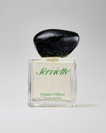 Perfume bottle with black cap and clear glass body on a white background