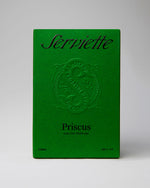 Green packaging of Serviette Priscus perfume with embossed logo on a gray background