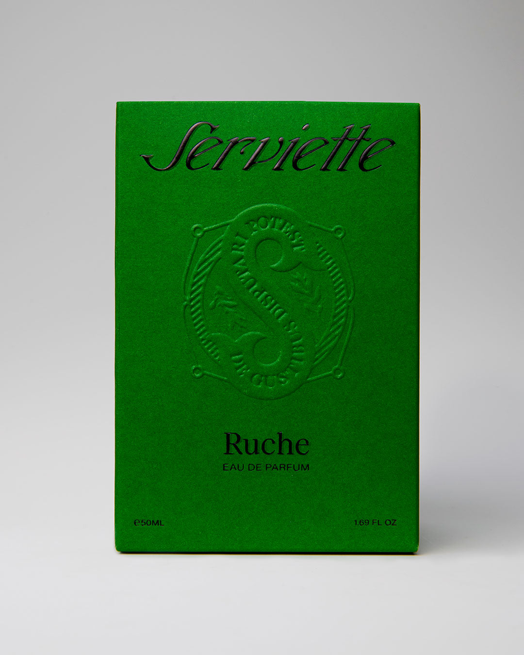 Green packaging of Serviette Ruche perfume with embossed logo on a gray background